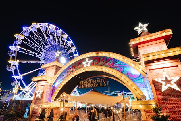 Top 10 Best Child-Friendly Christmas Markets in the Netherlands 32 Illuminated entrance arch and sparkling Ferris wheel at Amsterdam Winter Paradise Christmas Market. Nighttime holiday event featuring dazzling lights, family attractions, and festive atmosphere at the RAI Amsterdam in the Netherlands.