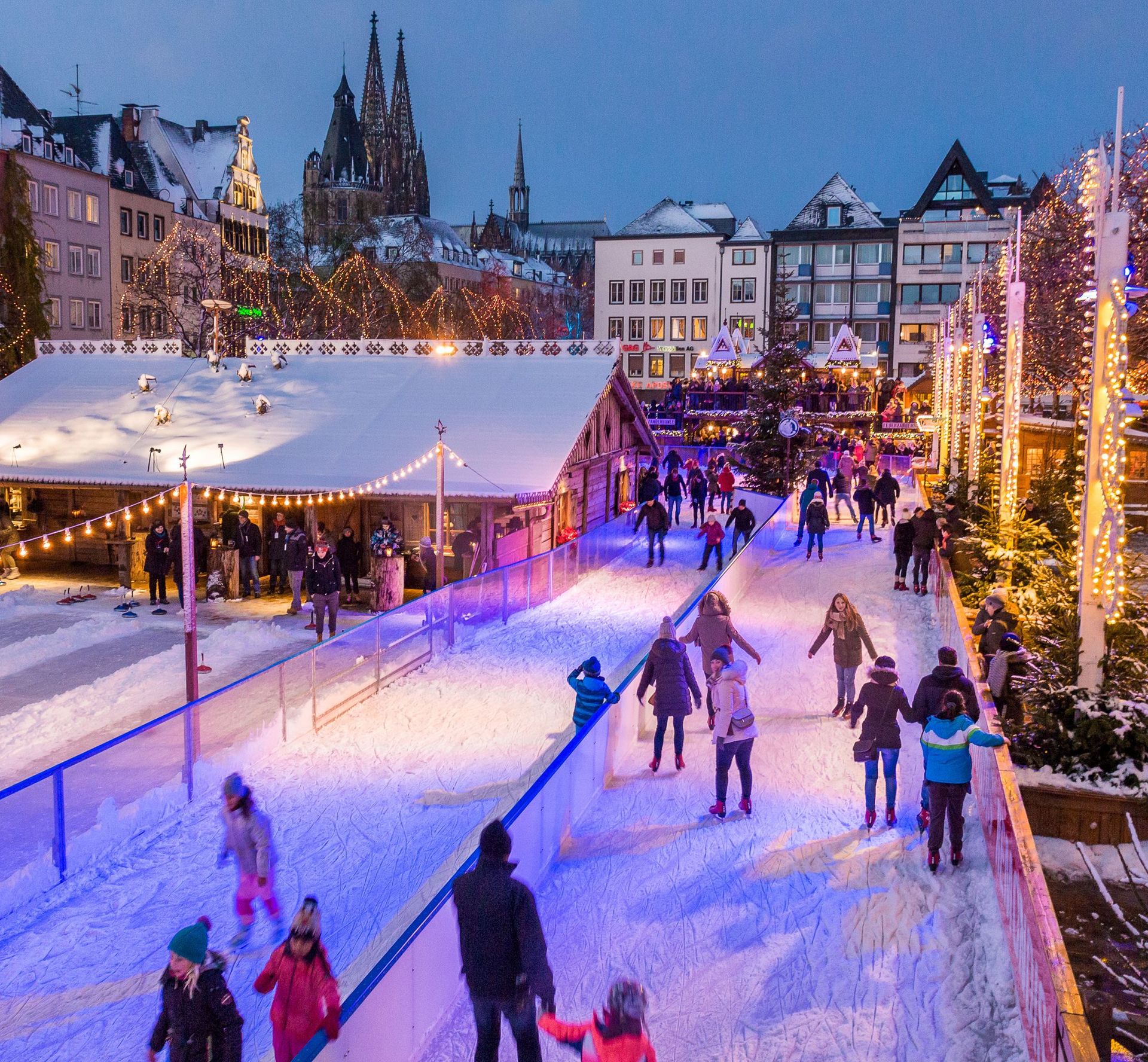 Enjoy winter fun at the Cologne Christmas Market with its enchanting ice skating rink and beautiful views of the illuminated cathedral. This lively holiday scene showcases sparkling decorations, families and friends skating, and the magical atmosphere in the heart of Cologne.
