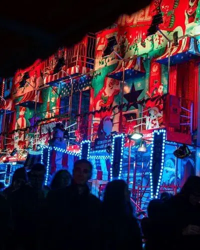 Top 10 Best Child-Friendly Christmas Markets in Belgium 94 Colorful illuminated fairground attraction at Hasselt Christmas Market in Belgium, with festive lights, cheerful crowds, and holiday-themed decorations creating a vibrant Winterland atmosphere at night.