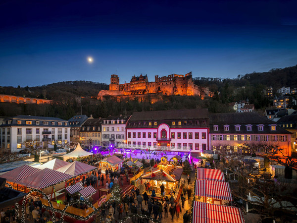 Experience the magic of Heidelberg Christmas Market as the illuminated castle towers over festive stalls, twinkling lights, and bustling crowds. This enchanting night scene captures traditional holiday celebrations and the romantic atmosphere in Heidelberg’s Altstadt