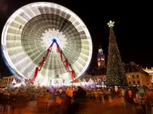 Top 10 Best Child-Friendly Christmas Markets in France 99 Lille Christmas Market in Grand Place with a sparkling Ferris wheel, giant decorated Christmas tree, and crowds celebrating under festive lights. Magical winter fun and holiday atmosphere in Lille, France.
