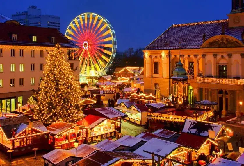 Top 10 Best Child-Friendly Christmas Markets in France 89 Golden Christmas tree, sparkling Ferris wheel, and illuminated stalls at Lyon Christmas Market, France. Visitors enjoy holiday shopping and winter celebrations in a vibrant city square at night.